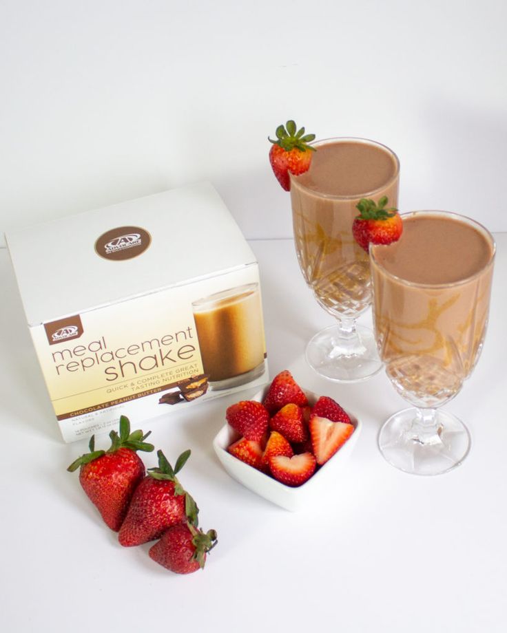 three glasses filled with liquid and strawberries next to a box of raspberries