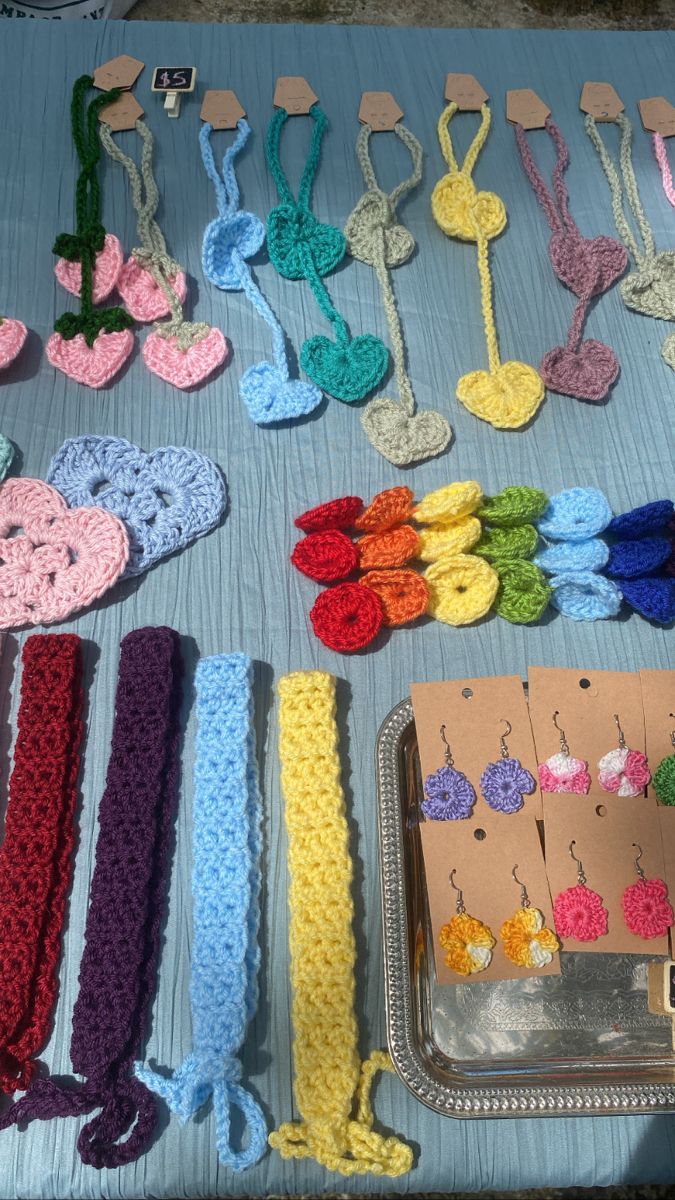 there are many crocheted items laid out on the table to be sewn