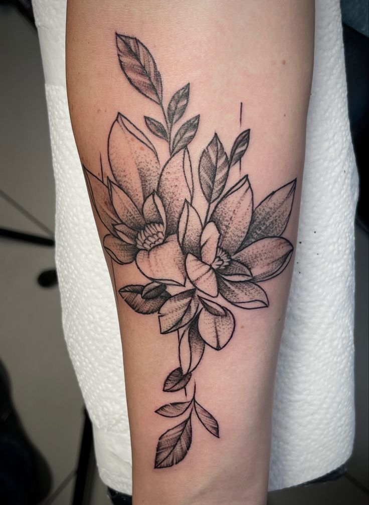 a black and white flower tattoo on the leg