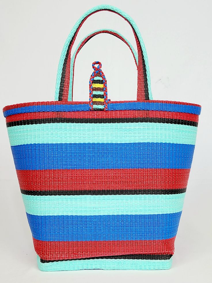 Material: Recycled plastic. Color: Red, blue, sky blue, black. Size: Height 12" Width 14" Use: Grocery, beach, pool... Property: Waterproof, easy to clean. Origin: West Africa. Handwoven bags made from recycled plastics. This bag is waterproof and very easy to clean. This material is very strong and can hold heavy contain. Casual Red Bucket Beach Bag, Blue Summer Packable Bag, Multicolor Recyclable Beach Bag For Vacation, Large Blue Beach Bag For Travel, Casual Multicolor Recyclable Bag, Packable Blue Bag For The Beach, Casual Blue Packable Beach Bag, Blue Recyclable Beach Bag For Summer, Large Blue Beach Bag For Everyday Use