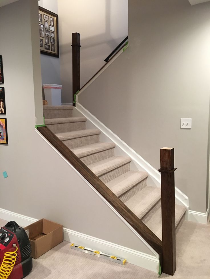 there is a luggage bag sitting on the floor next to some stairs in this house