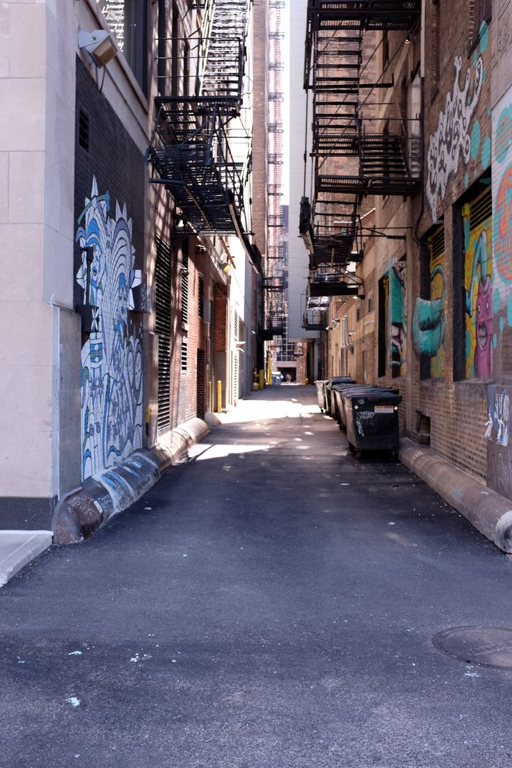 an alley way with graffiti on the walls