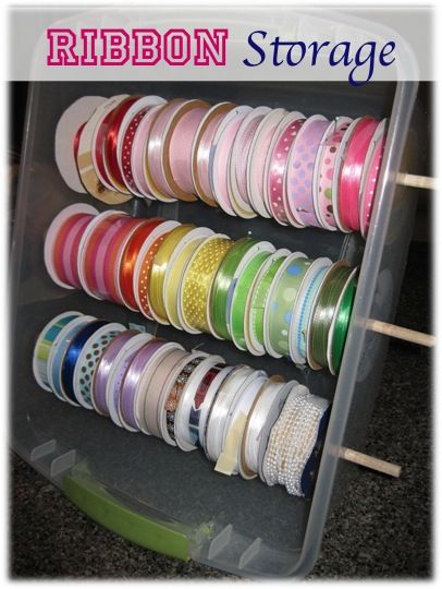 a plastic container filled with lots of different colored tapes