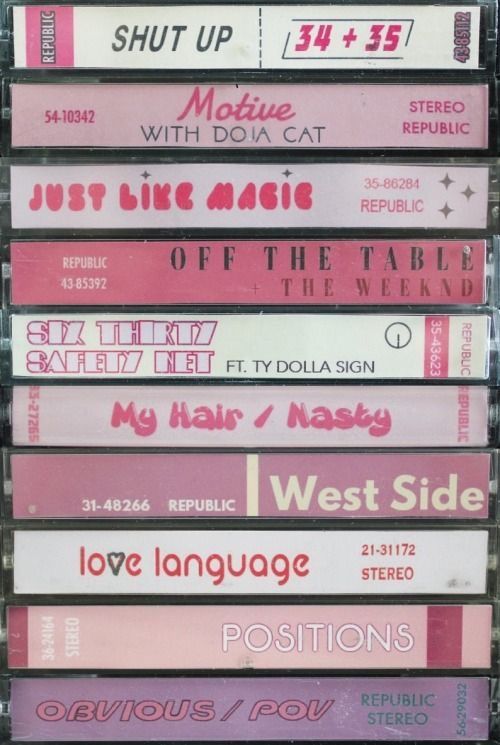 cassettes stacked on top of each other in front of a white background with pink lettering