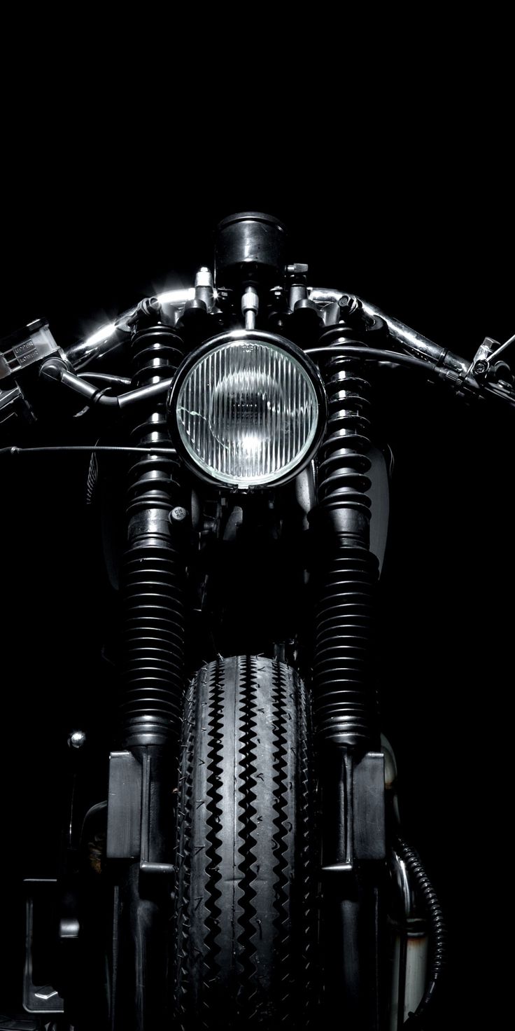 the front end of a motorcycle with its lights on