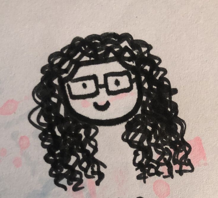 a drawing of a girl with glasses and curly hair on a piece of white paper