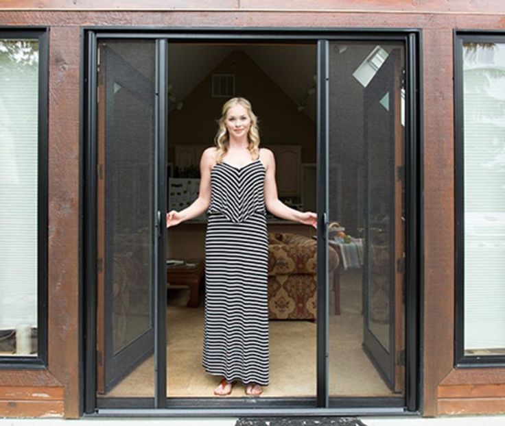 a woman standing in the doorway of a house