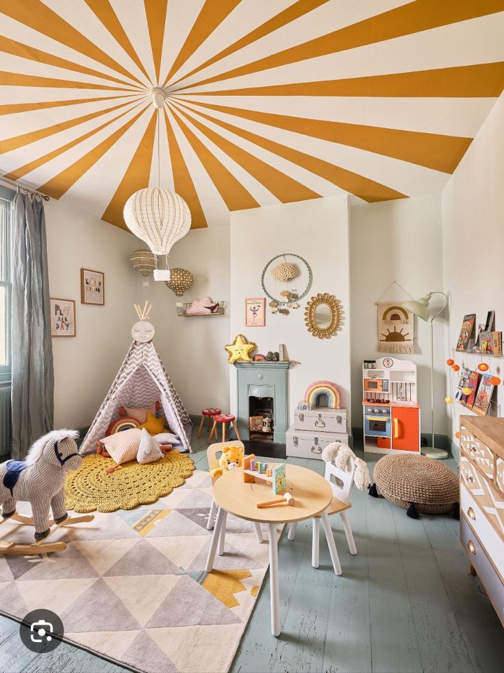 a child's room with a teepee tent and toys