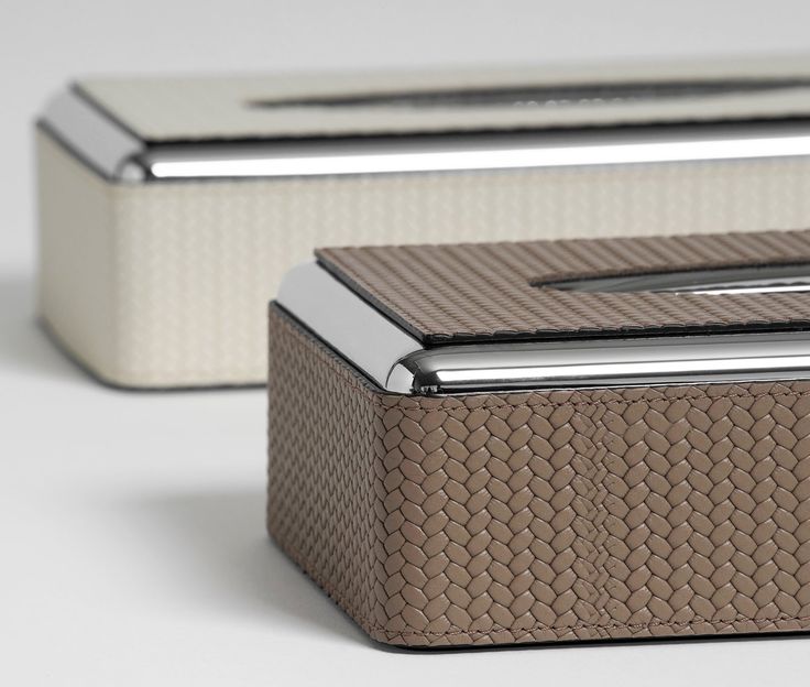 two silver and brown boxes sitting next to each other on a white surface with no one in it