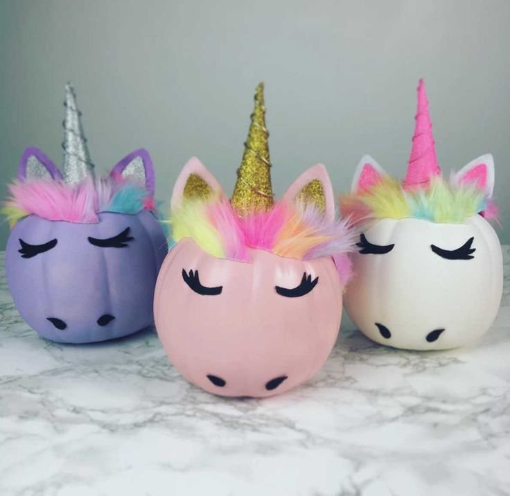 three different colored unicorns with their eyes closed