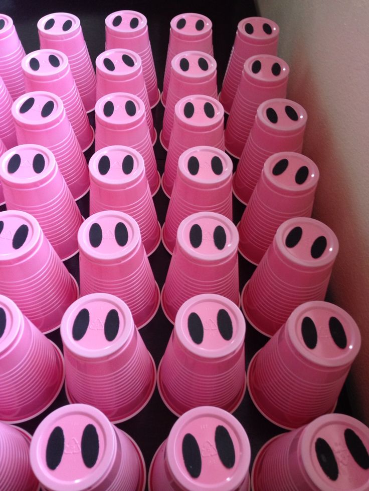 many pink cups with black eyes are stacked together