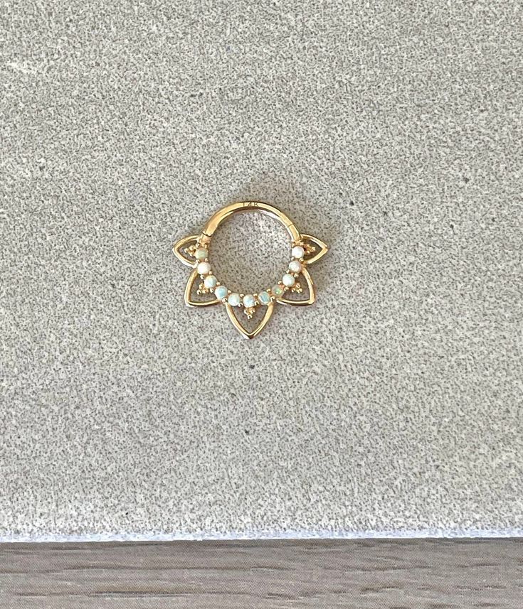 "This solid gold 8mm or 10mm septum piercing ring is made of 14K gold, and has faux opals. Please note that the 10mm size has one extra set of \"spikes\" because of the larger size. Piercing \"clicks\" into place. Super dainty minimalist look - drop jaws with this body jewelry! **Please upgrade to priority shipping at checkout for an additional $3 if you would like to insure your package! I am not responsible for lost, delayed or stolen packages.** Details & Size: ♥ 14k Gold - Yellow or White Go Elegant 14k Gold Hypoallergenic Septum Ring, Gold Stackable Septum Ring For Everyday, Hypoallergenic 14k Gold Septum Ring, 14k Gold Septum Ring With Halo Detail, Dainty 14k Gold Septum Ring, 14k Gold Septum Ring With Halo, Dainty 14k Gold Round Septum Ring, 14k Gold Dainty Round Septum Ring, 14k Gold Halo Septum Ring