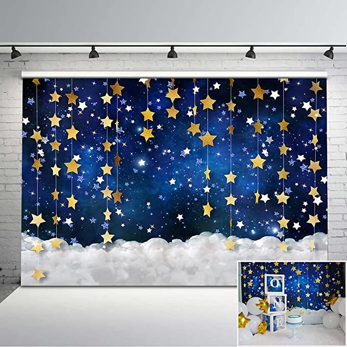 a wall hanging on the side of a white brick building with stars in the sky