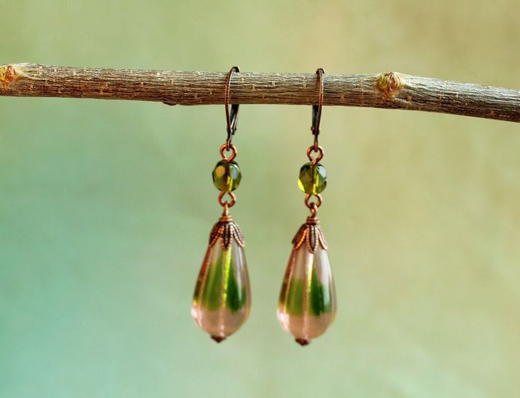 Gorgeous two-toned glass teardrop dangle earring. The focal beads are even better in real life. Olive green and light pink mix in this melon-grooved glass Czech bead.  - Dimensions of item are shown in photos - Lead and nickel free. - For more listings, please visit https://www.etsy.com/shop/WildWaresJewelry - All packaging for Wild Wares products either contains recycled material, reused material and/or is compostable. No new non-biodegradeable plastic is used. Green Teardrop Drop Earrings For Jewelry Making, Green Teardrop Czech Glass Jewelry, Handmade Green Teardrop Earrings, Green Czech Glass Teardrop Jewelry, Green Bohemian Teardrop Drop Earrings, Bohemian Green Teardrop Drop Earrings, Green Bohemian Teardrop Earrings, Bohemian Green Teardrop Earrings, Focal Beads