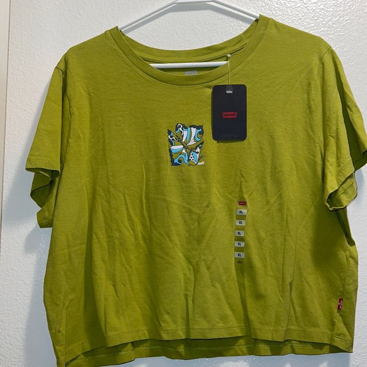 Nwt!! Brand New Never Worn - Size Extra Large Short Sleeved Cropped Graphic Levi’s Tee Of Butterfly Color: Olive Green In Perfect Condition (Brand New) Levi's Crew Neck Tops For Summer, Green Levi's Cotton Tops, Levi's Green Cotton Tops, Levi's Graphic Print Tops For Spring, Trendy Levi's Graphic Print Tops, Levi's Casual Tops With Graphic Print, Levi's Cotton Short Sleeve Top, Levi's Casual Top With Graphic Print, Trendy Levi's Cotton Tops