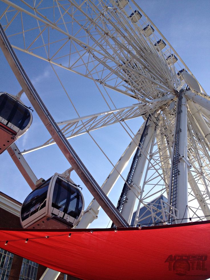 the ferris wheel is on display in front of some buildings