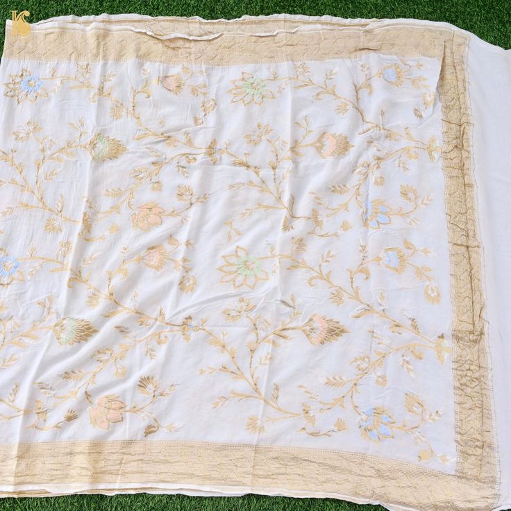 Elevate your style with our Pure Georgette Silk Meenakari Banarasi Dupatta. This luxurious banarasi dupatta showcases intricate Meenakari work, adding timeless charm and regality to your ensemble. Celebrate Banaras' artistry and heritage. White Jamawar Sets With Dupatta, White Dola Silk Dupatta For Seasonal Wear, White Dola Silk Dupatta For Transitional Season, White Raw Silk Blouse Piece For Eid, Transitional White Dola Silk Dupatta, White Katan Silk Dupatta With Pallu, White Dola Silk Unstitched Suit With Zari Work, Unstitched Raw Silk Salwar Kameez With Meenakari, White Banarasi Silk Semi-stitched Suit