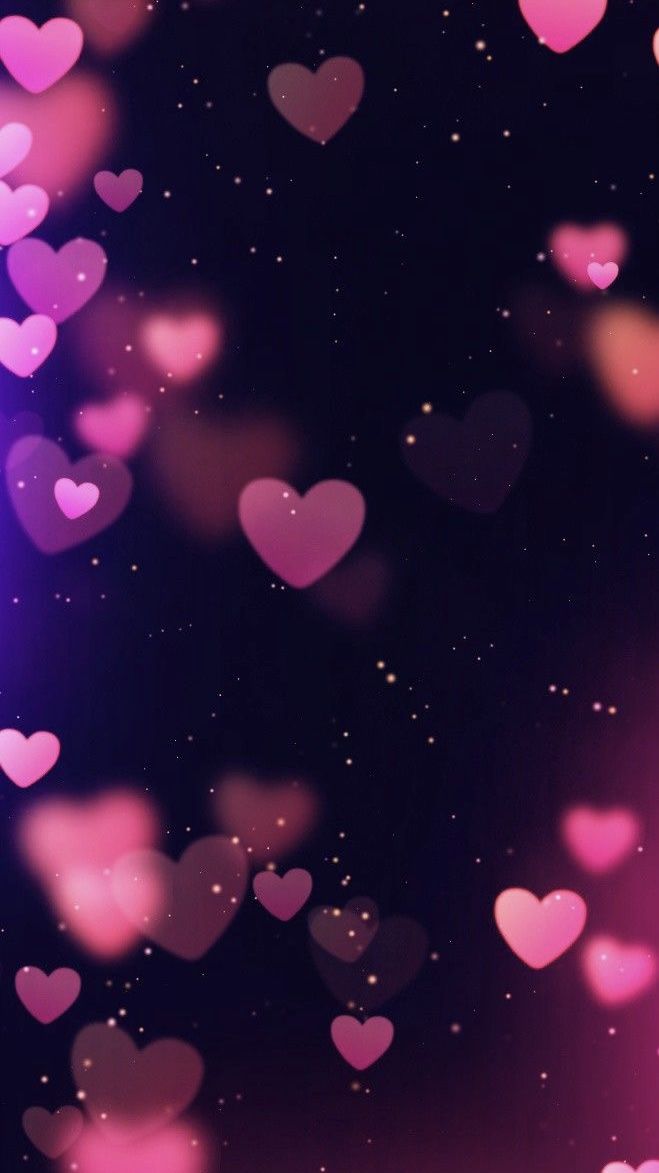 many pink hearts floating in the air on a black background with stars and sparkles