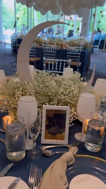 the table is set up for an event with blue linens and white place settings