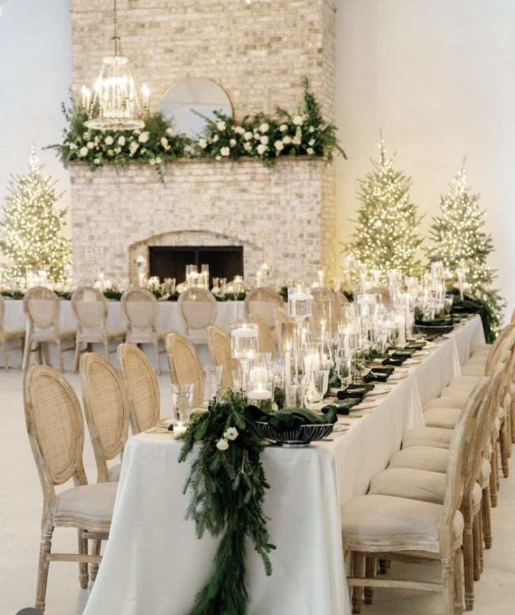 a long table is set up with candles and greenery for an elegant winter wedding