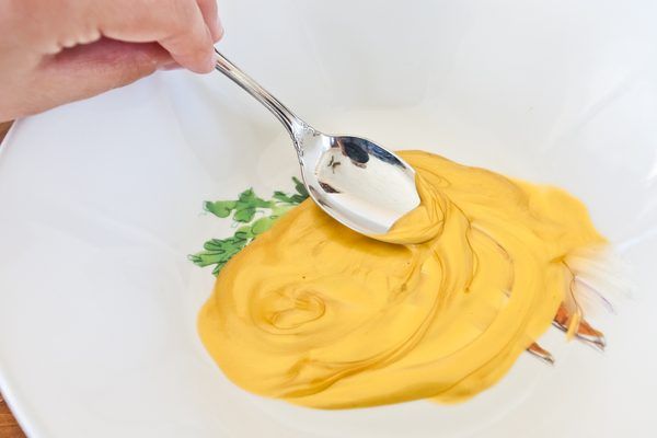 a spoon is being used to dip something into a bowl