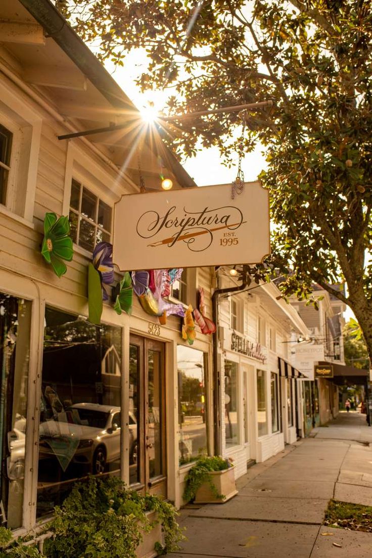 the sun shines brightly through the windows of an antique store on a city street