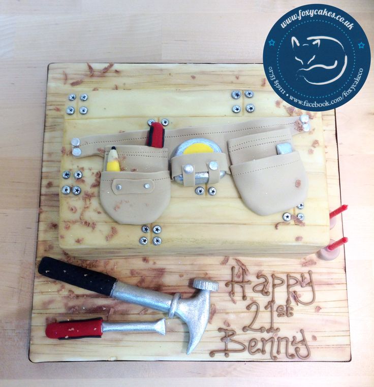 a birthday cake with tools on it and the words happy 2nd birthday written in frosting