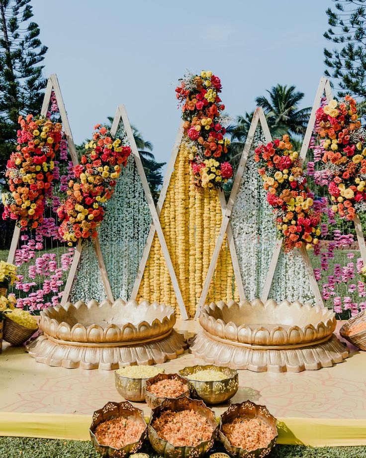 an elaborate display with flowers and fruit on the table