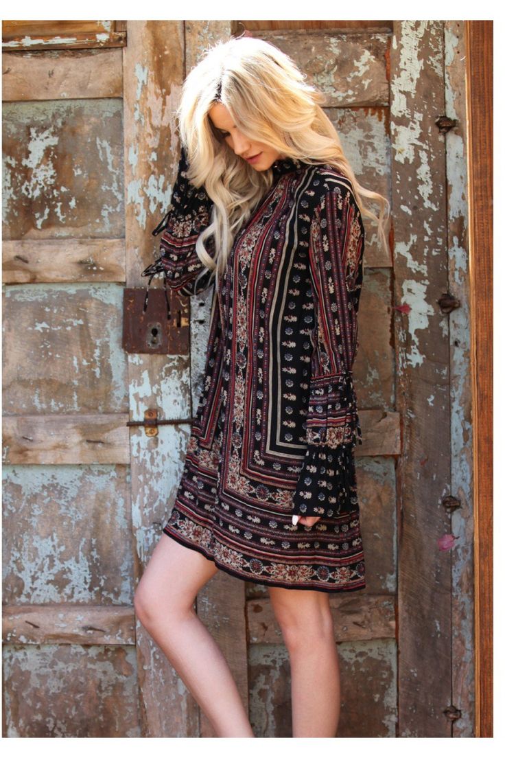 This dress has a really nice bohemian print. It features a choker neckline with front & back keyholes, double tie sleeves, a removable tie at the waist and an a-line mini silhouette. Small Bust 40" Length 33" : Med Bust 42" Len 332" : Large Bust 44" Len 32" light weight rayon Black Boho Dress With Boho Print, Black Boho Print Dress For Festival, Black Bohemian Dress With Boho Print, Black Boho Dress With Print For Spring, Black Boho Dress With Boho Print For Spring, Black Bohemian Mini Dress With Floral Print, Bohemian Black Mini Dress With Floral Print, Black Flowy Boho Dress With Boho Print, Black Printed Mini Dress For Fall