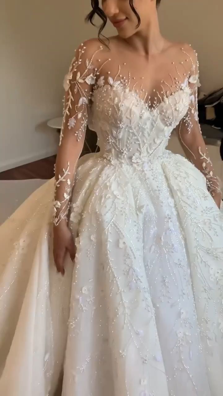 a woman in a white wedding dress is posing for the camera