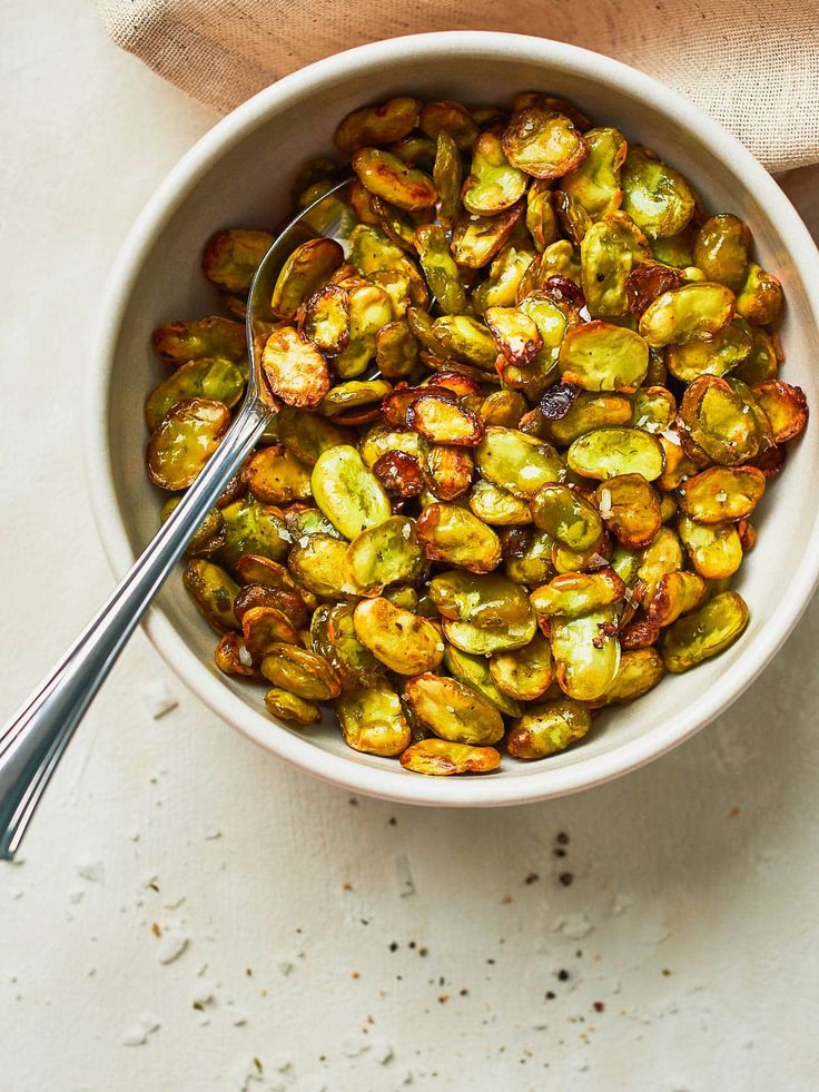 a white bowl filled with brussel sprouts on top of a table