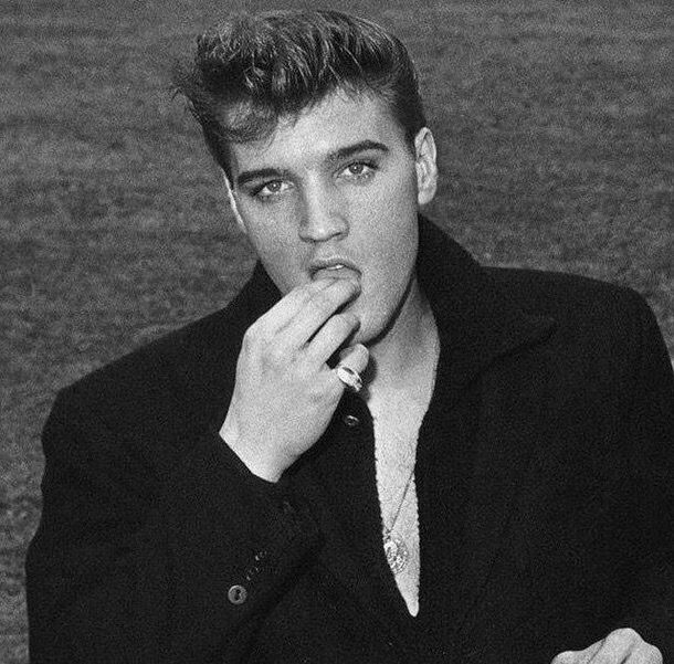 black and white photograph of a young man with his hand on his mouth