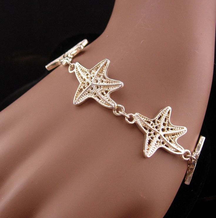 This beautiful never worn starfish bracelet would make a great gift for the ocean lover. IT is thick and well made and would be perfect for your favorite mermaid! 12-2-20 Ocean-inspired Bracelet With Starfish Charm, Metal Starfish Jewelry, Ocean-inspired Starfish Charm Bracelet, Adjustable Starfish Charm Jewelry, Elegant Starfish Bracelet For Gift, Starfish Charm Bracelet As Gift, Star-shaped Bracelet With Starfish Charm Gift, Elegant Starfish Bracelets For Beach, Silver Starfish Bracelet For Gift