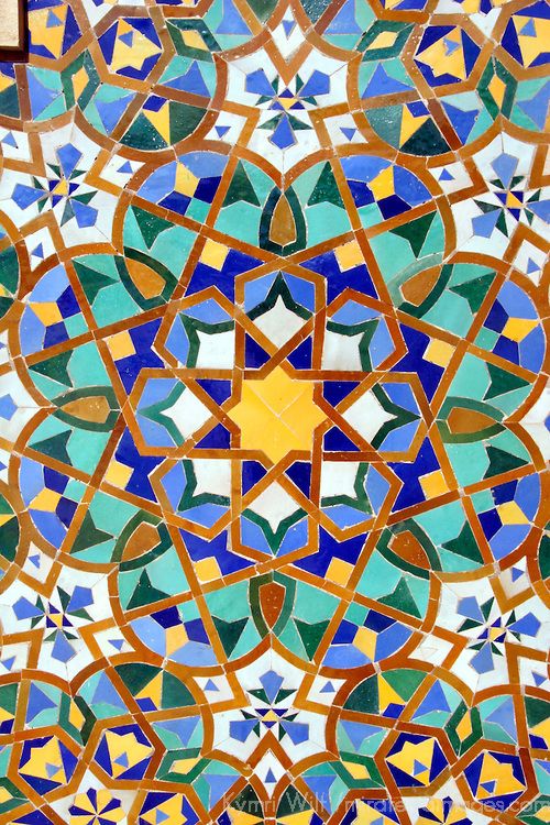 an intricately designed tile with blue, green and yellow colors