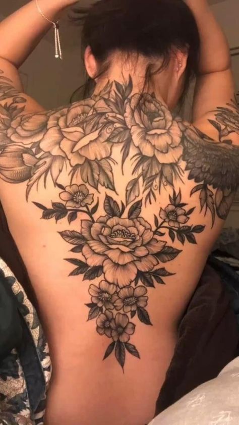 the back of a woman's body with flowers on it