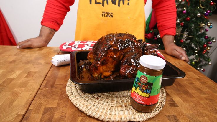 a person standing at a table with some food in front of them and a can of ketchup next to it