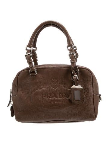 Prada Shoulder BagBrown Vitello Daino LeatherSilver-Tone HardwareDual Shoulder StrapsLogo Jacquard Lining & Dual Interior PocketsZip Closure at TopProtective Feet at BaseIncludes Dust Bag, Lock, Keys, Clochette & Luggage TagUnfortunately, due to restrictions, this item may not be eligible for shipping in all areas. Brown Leather Bag With Logo Plaque, Brown Formal Bags With Logo Plaque, Formal Brown Bag With Logo Plaque, Formal Brown Bags With Logo Plaque, Vintage Prada Bag, Prada Runway, Jordan Jewelry, Gold Girl, Loewe Bag