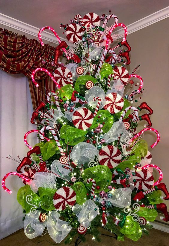 a christmas tree decorated with candy canes and bows