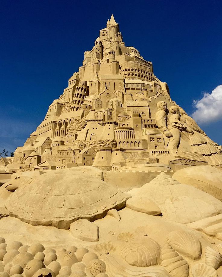 a very large sand castle made to look like it's been built on the beach