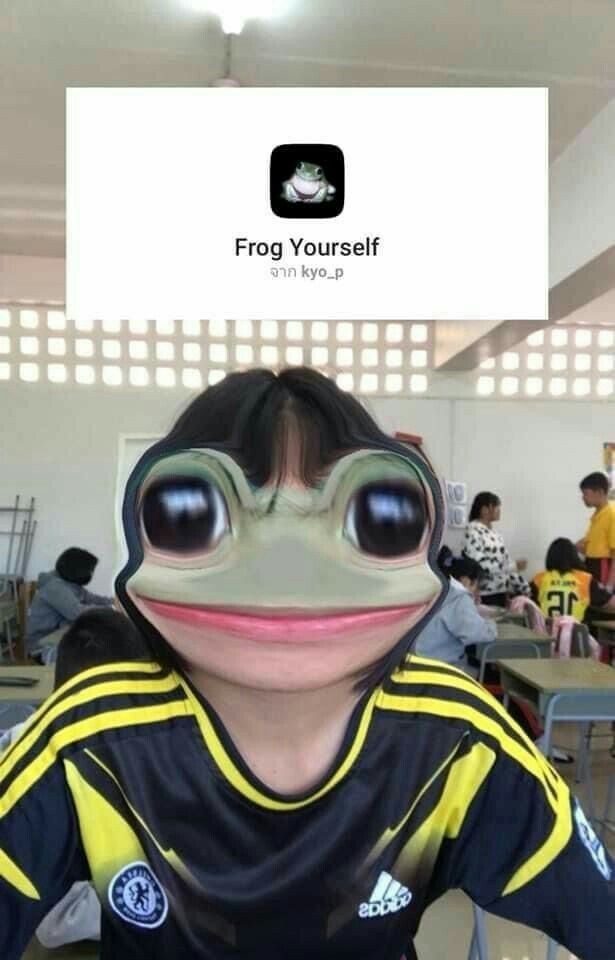 the frog is wearing a soccer jersey and goggles for his eyes are wide open