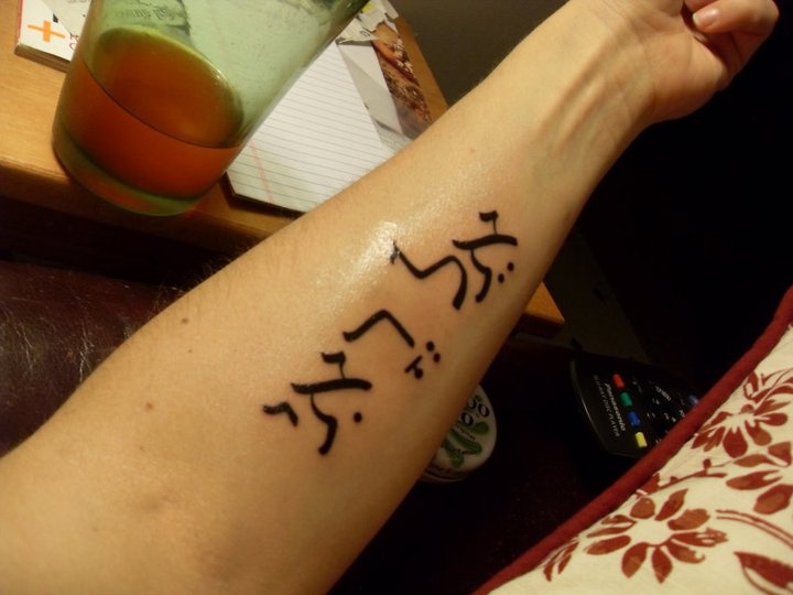 a person with a tattoo on their arm that has hebrew characters written on the wrist