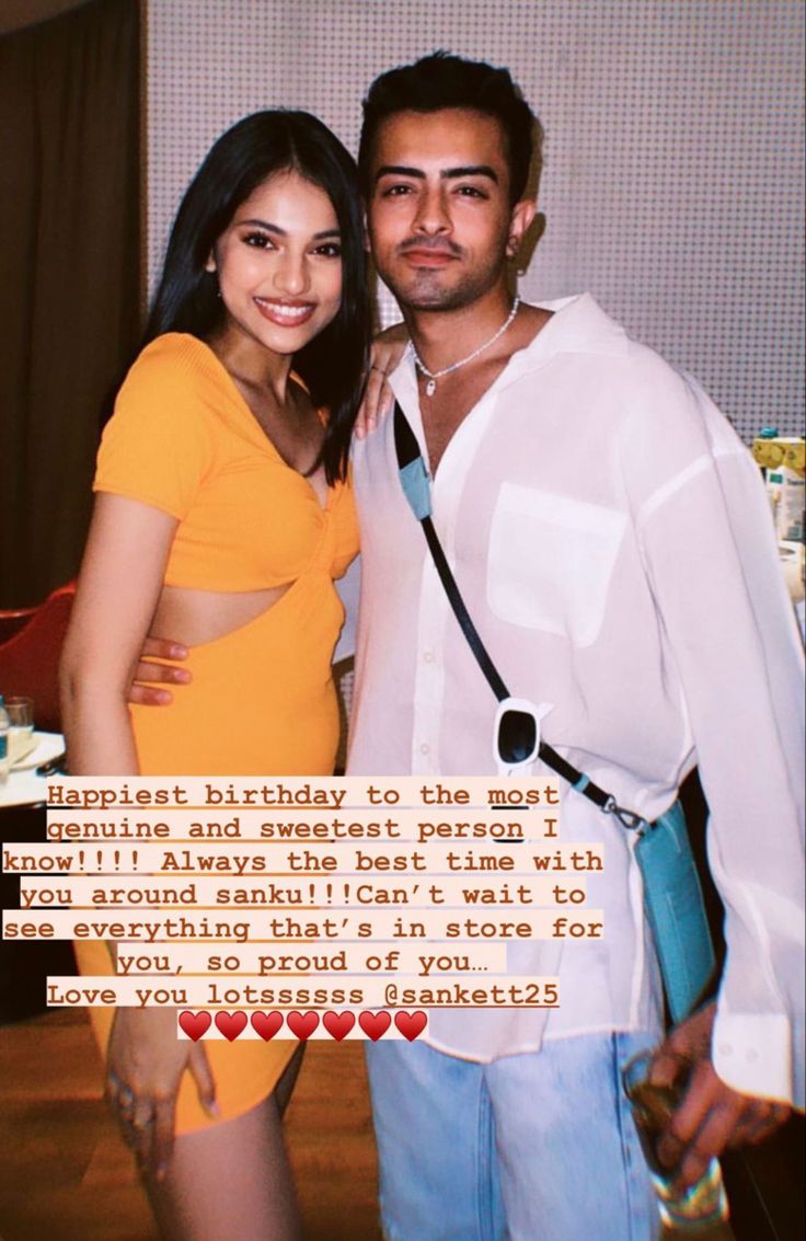 a man and woman standing next to each other in front of a cake with words written on it