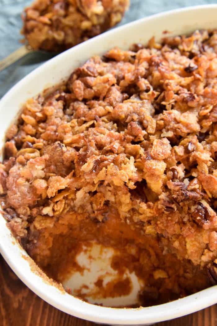 a casserole dish filled with baked goods on top of a wooden table