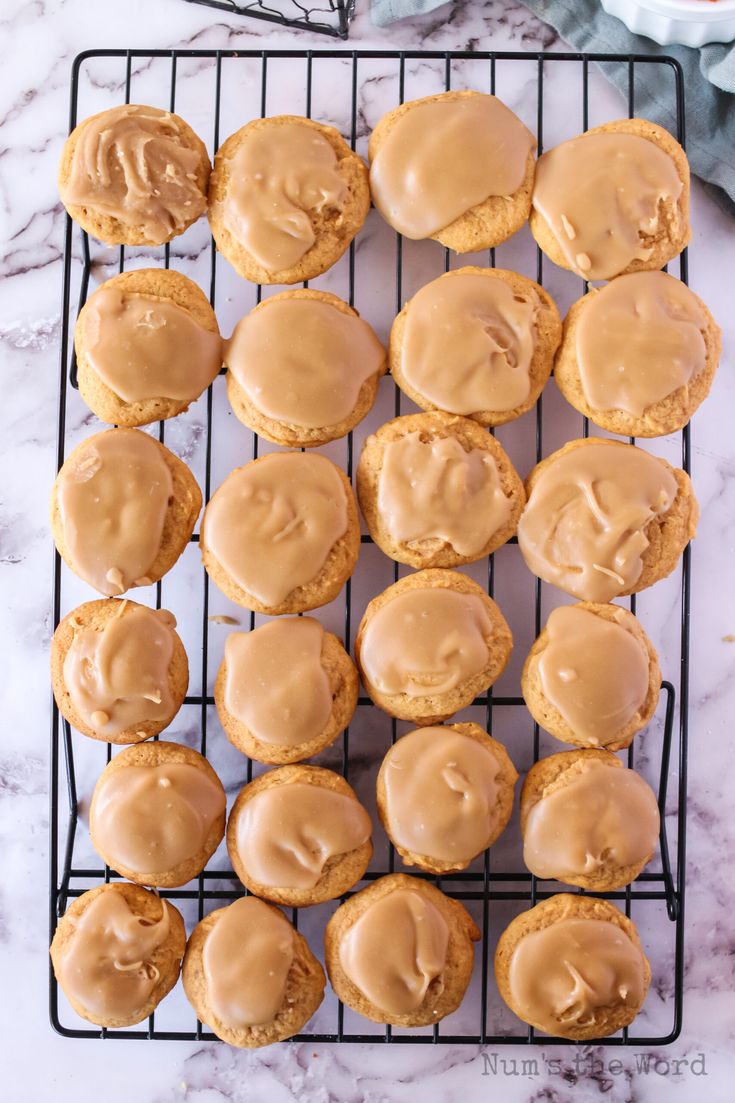 peanut butter frosted cookies cooling on a wire rack