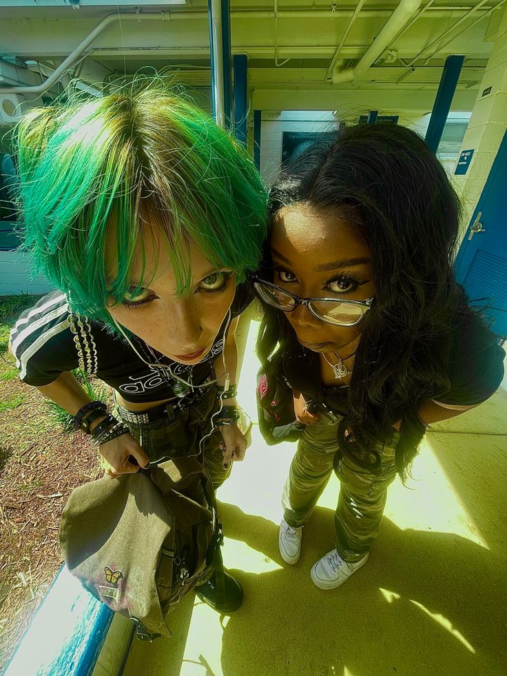 two young women with green hair posing for the camera