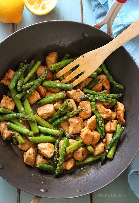 chicken and asparagus stir fry in a pan