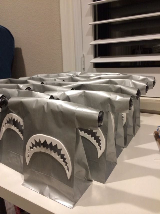 some bags with shark teeth on them sitting on a table