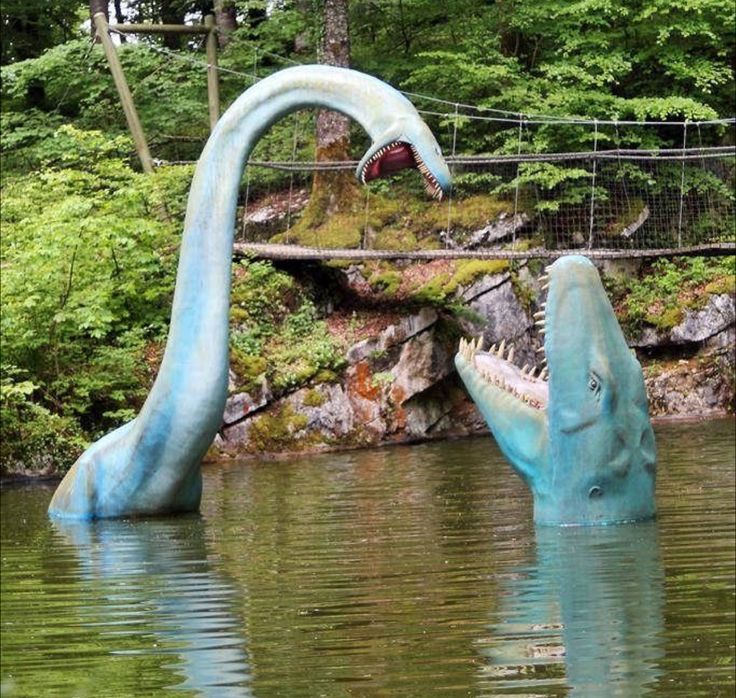 two large blue dinosaurs in the water