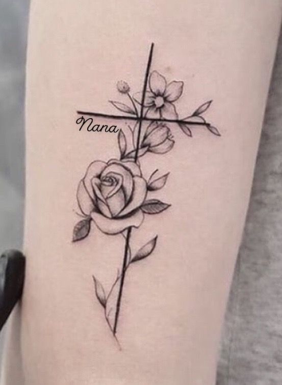 a cross with flowers on it and the word nama written in black ink above