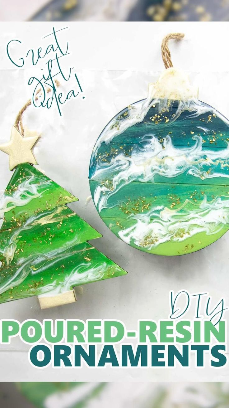 an ornament with green and white swirly paint on it next to a christmas tree